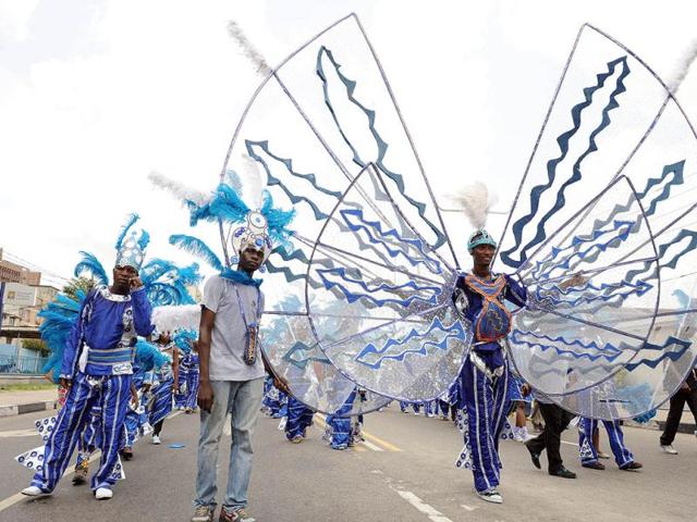 A man showcases his costume in a procession during the annual Lagos carnival. The carnival celebrates the Easter festival and the rich cultural heritage of of the stateolis. AFP PHOTO: PIUS UTOMI EKPEI