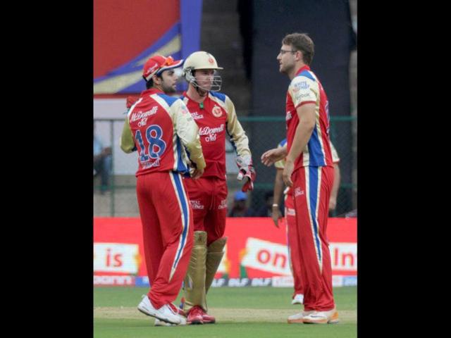 Royal Challengers Bangalore team members celebrate the fall of wicket of Kolkata Knight Riders Jacques Kallis during the IPL 5 at M Chinnaswamy stadium in Bangalore. Agency