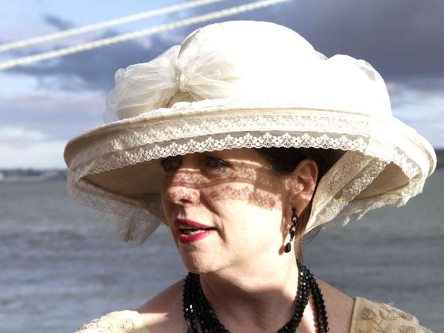 Mary Beth Crocker, from Newport Ky. poses for pictures in period costume as she and her husband disembark the MS Balmoral Titanic memorial cruise ship at its first stop in Cobh, Ireland. (AP Photo/Lefteris Pitarakis)