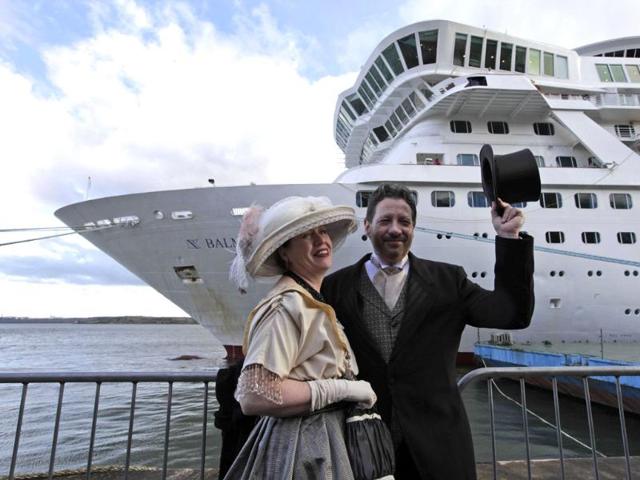 Mary Beth Crocker, left, and her husband Tom Dearing from Newport Ky. pose for pictures in period costume as they disembark the MS Balmoral Titanic memorial cruise ship at its first stop in Cobh, Ireland. (AP Photo/Lefteris Pitarakis)