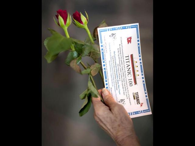 A woman poses holding roses and her invitation ahead of a memorial service marking 100 years since the RMS Titanic set sail on its ill-fated maiden voyage at Southampton dock. (AFP photo/Ben Stansall)