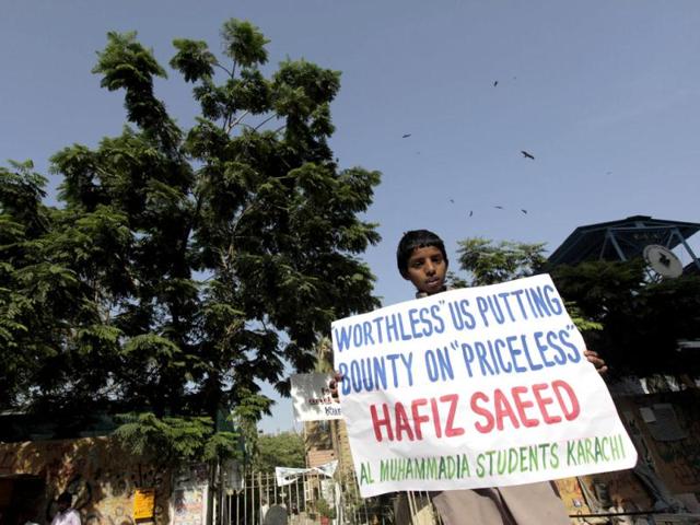 A supporter of Al Muhammadia Students, a religious group, holds a placard while taking part with dozens others in an anti-American rally in Karachi. Dozens of students gathered in a rally to condemn the American decision to place a $10 million bounty on its leader Hafiz Saeed, the Islamist suspected of masterminding the 2008 Mumbai attack. (Reuters)