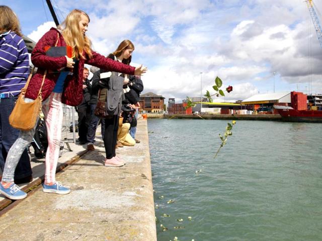 Various descendants of victims of the Titanic disaster cast roses into the dock at Southampton, England, from where the ill-fated luxury passenger liner sailed 100-years ago today. AP