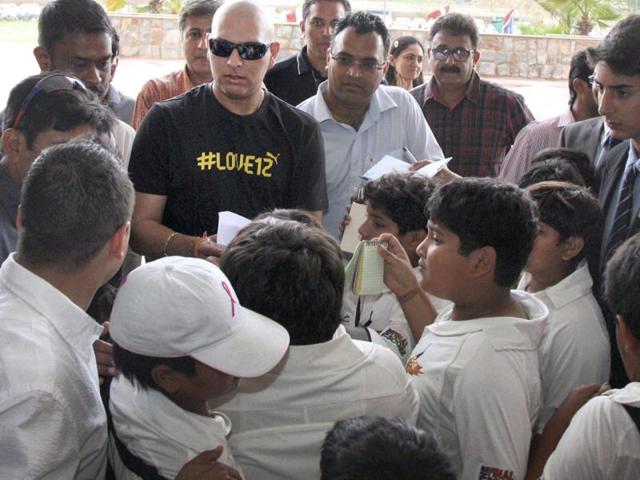 Cricketer Yuvraj Singh signs autograph for young fans after addressing a press conference in Gurgaon. PTI Photo