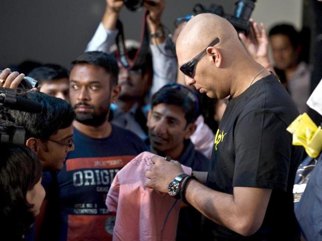 Cricketer Yuvraj Singh signs autographs following a press conference in Gurgaon. (AFP photo/ Prakash Singh)