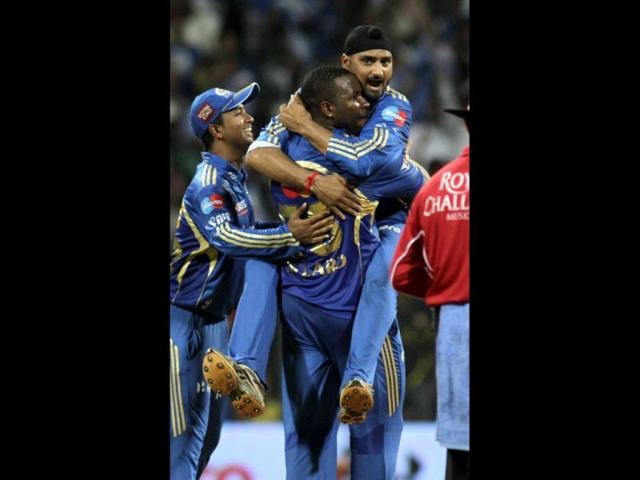 Kieron Pollard of Mumbai Indians hugs Harbhajan Singh as he celebrates the dismissal of Amit Singh of Rajasthan Royals during their Indian Premier League (IPL) cricket match in Mumbai. AP Photo/Rajanish Kakade
