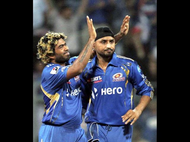 Mumbai Indians players Harbhajan Singh and Lasith Malinga celebrate the wicket of Rajasthan Royals' Owais Shah during their IPL-5 match in Mumbai. PTI Photo/Shirish Shete