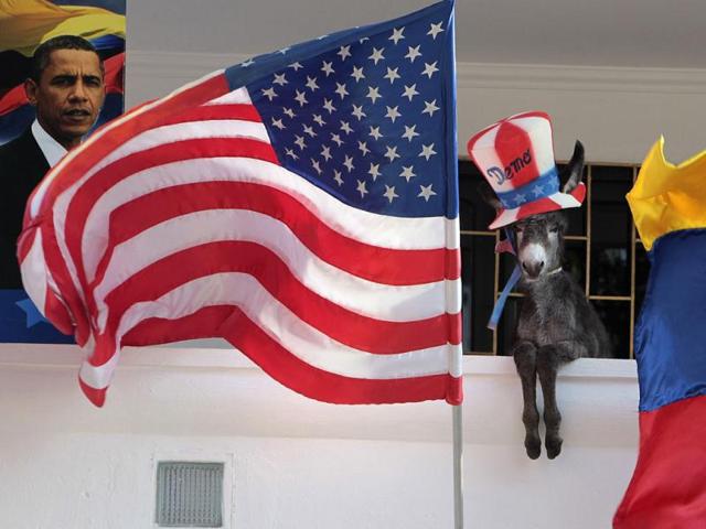 A baby donkey named Demo belonging to Colombian attorney Silvio Carrasquilla, dressed as the mascot of the US Democratic Party, stands where it was placed in a pose by Carrasquilla between the US and the Colombian flags, at his home in Turbaco, near Cartagena. Carrasquilla, Turbaco's former mayor who considers himself Colombia's number one fan of US President Barack Obama, is sprucing up his house by painting it the red, white and blue of the US flag to celebrate Obama's arrival in Cartagena for the VI Summit of the Americas. Reuters/Joaquin Sarmiento
