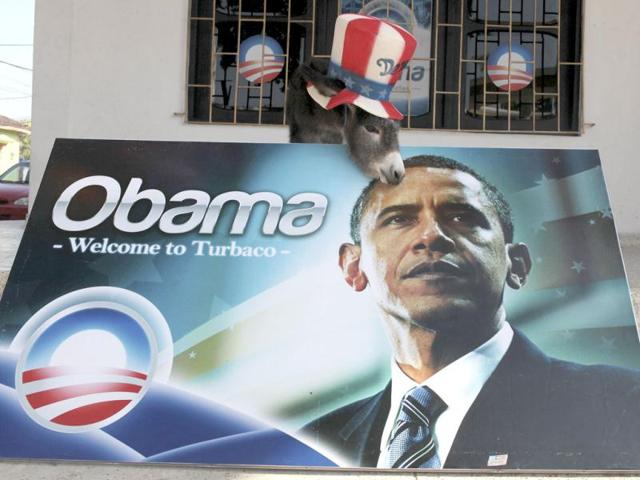 A baby donkey named Demo by its owner, Silvio Carrasquilla, stands dressed as the mascot of the US Democratic Party behind a poster of US President Barack Obama, outside Carrasquilla's home in Turbaco, near Cartagena. Carrasquilla, Turbaco's former mayor who considers himself Colombia's number one Obama fan, is sprucing up his house by painting it the red, white and blue of the US flag to celebrate Obama's arrival in Cartagena for the VI Summit of the America. Reuters/Joaquin Sarmiento