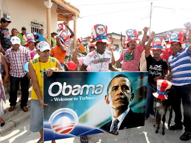 People hold a banner with an image of President Barack Obama during a traditional parade of donkeys in Turbaco, some 20 km south of Cartagena, Colombia. Leaders of the western hemisphere, including Obama, will meet for the 6th Summit of the Americas April 15 and April 16 in Cartagena. AP Photo/Pedro Mendoza