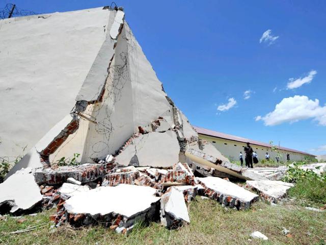 Officials of the Banda Aceh prison examine the damage to a wall a day after a powerful earthquake hit the west coast of Indonesia. AFP/Adek Berry
