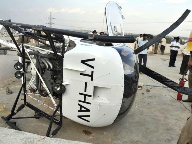 The Schweizer helicopter that made an emergency landing on the rooftop of a residential building in Bangalore. A trainee helicopter pilot made an emergency landing after developing engine trouble. (AFP Photo)