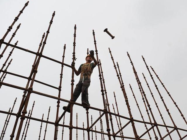 A labourer working on scaffolding at a construction site in Hefei, in eastern China's Anhui province. AFP Photo