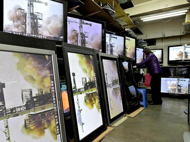 A woman watches a TV news showing a file video of North Korea's missile launch at a home appliance retailer in Seoul, South Korea. AP Photo/Lee Jin-man