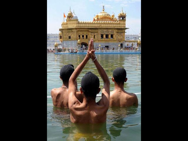 Sikh devotees take a holy dip in the sarover (water tank) at the Golden Temple in Amritsar. Baisakhi is an ancient harvest festival in the Punjab and Nepal region, which also marks the beginning of a new solar year and a new harvest season. AFP/Narinder Nanu