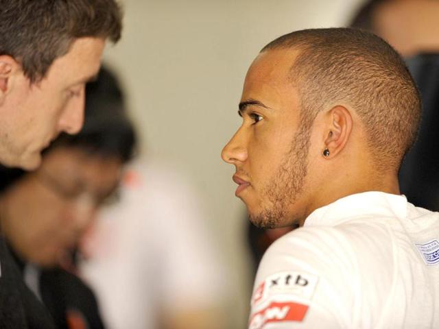McLaren-Mercedes driver Lewis Hamilton of Britain talks to his engineer in the garage after the third practise session for Formula One's Chinese Grand Prix at the Shanghai International Circuit. AFP Photo/Peter Parks
