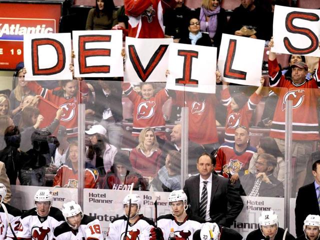 Fans hold up a sign over the bench of the New Jersey Devils during the third period of their NHL Eastern conference quarterfinal playoff hockey game against the Florida Panthers in Sunrise, Florida. Reuters photo/Rhona Wise