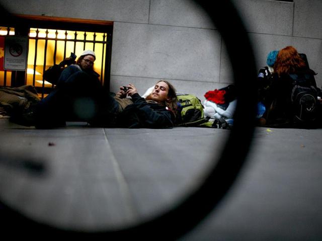 Protesters with the Occupy Wall Street movement sit and lie on the sidewalk in front of the New York Stock Exchange in New York. Reuters photo/Eric Thayer