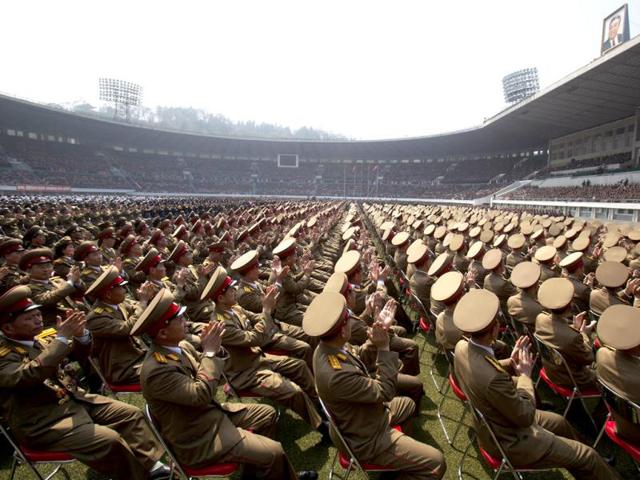 A crowd of North Korean military members look up to a stadium podium and applaud the country's leader Kim Jong Un and senior military and government officials during a meeting of the Central Committee of North Korea's ruling party in Pyongyang. AP Photo/David Guttenfelder