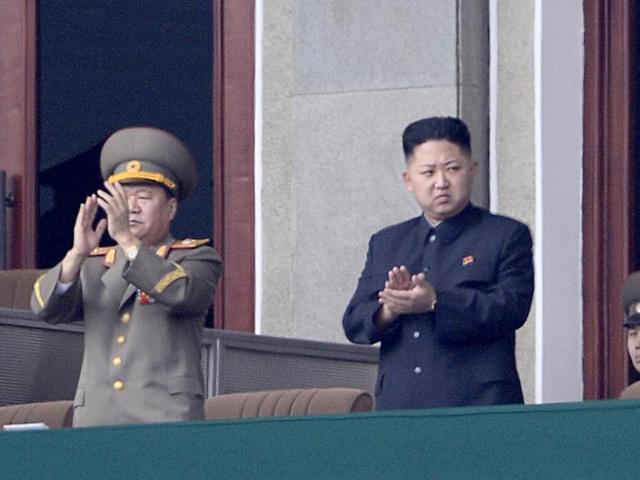 North Korean leader Kim Jong-Un (C) applauds during a official ceremony at a stadium in Pyongyang. AFP Photo/Pedro Ugarte