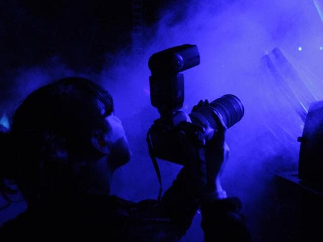 A photographer shoots Jarvis Cocker performing with Pulp at the Coachella Valley Music and Arts Festival in Indio, California. (Reuters/David McNew)