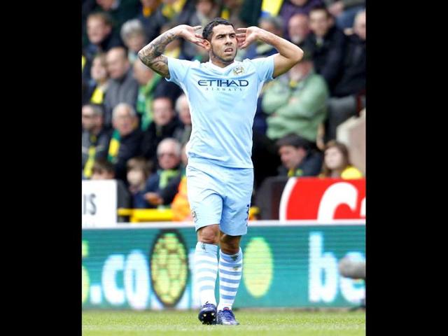 Manchester City striker Carlos Tevez celebrates scoring the opening goal of the English Premier League football match against Norwich City at Carrow Road stadium in Norwich, England. AFP Photo/Ian Kington
