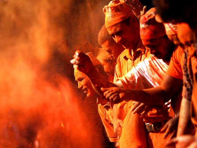 Nepalese devotees throw vermilion powder on each other during Sindur Jatra festival in Thimi, on the outskirts of Katmandu, Nepal. Sindur Jatra Festival, is celebrated to welcome the advent of spring and the New Year. (AP Photo/Niranjan Shrestha)