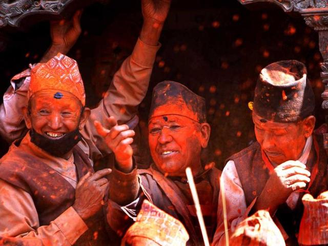 Nepalese devotees smeared with vermilion powder participate in Sindur Jatra festival in Thimi, on the outskirts of Katmandu, Nepal. Sindur Jatra, or Vemillion Powder Festival, is celebrated to welcome the advent of spring and the New Year. (AP Photo/Niranjan Shrestha)