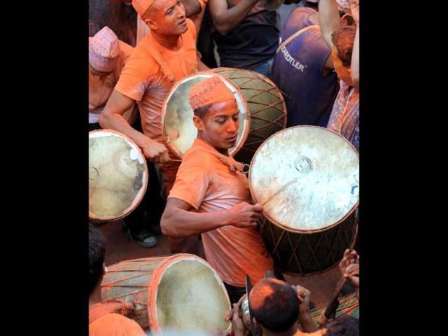 Nepalese devotees, covered in color vermilion powder, beat drums and dance as they carry palanquins with deities during Sindur Jatra festival in Thimi, on the outskirts of Katmandu, Nepal. Sindur Jatra, or Vemillion Powder Festival, is celebrated to welcome the advent of spring and the New Year. (AP Photo/Binod Joshi)