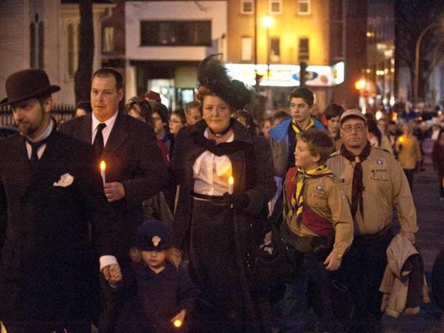 People gather at Halifax remember Titanic sinking with funeral procession, song and performance Night of the Bells event in the Grand Parade square to mark the sinking of the RMS Titanic. (AFP/Rogerio Barbosa)