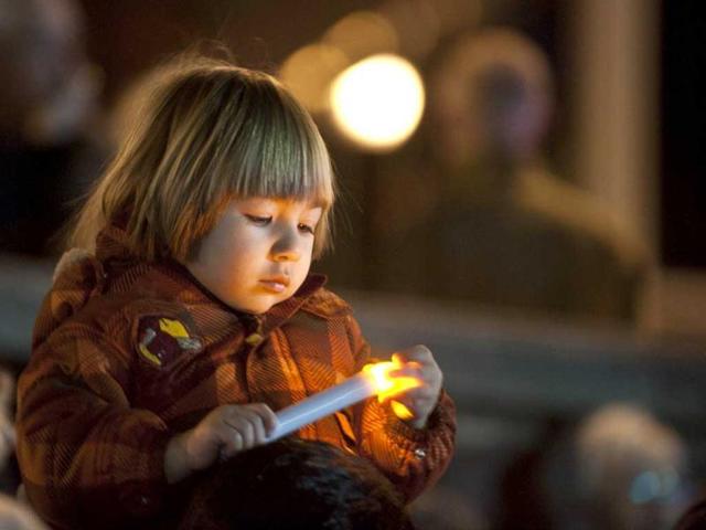 People gather at Halifax remember Titanic sinking with funeral procession, song and performance Night of the Bells event in the Grand Parade square to mark the sinking of the RMS Titanic. (AFP/Rogerio Barbosa)