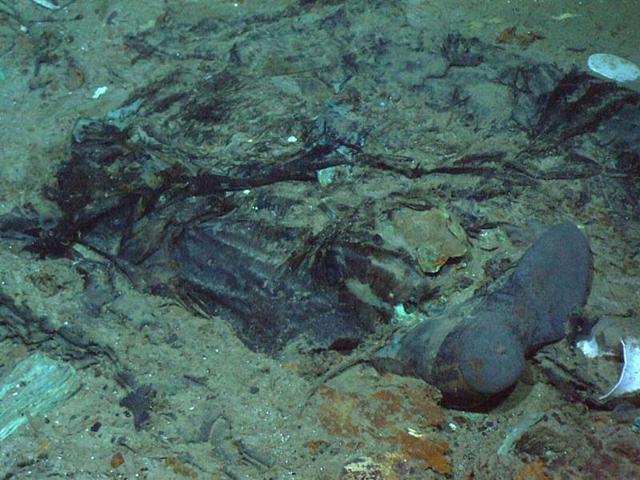 This photo shows the remains of a coat and boots, articulated in the mud on the sea bed near Titanic's stern, are suggestive evidence of where a victim of the disaster came to rest. (AP/Institute for Exploration)