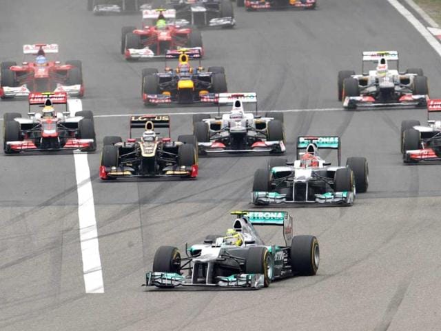 Nico Rosberg leads his teammate Michael Schumacher and other cars during the start of Chinese Grand Prix in Shanghai. (AFP Photo/Liu Jin)