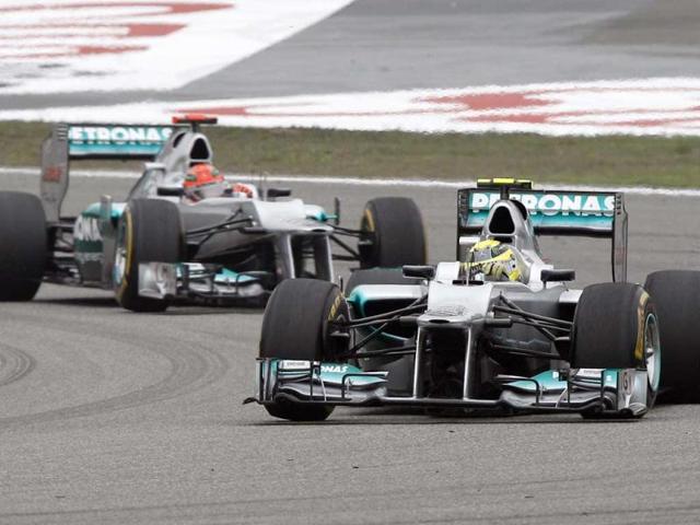 Nico Rosberg leads teammate and compatriot Michael Schumacher into turn two at the start of the Chinese Formula One Grand Prix in Shanghai. (AP Photo/Mark Baker)