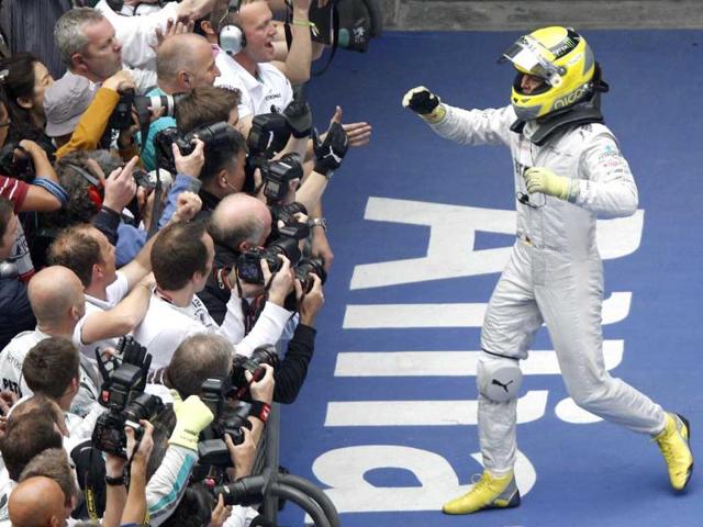 Nico Rosberg of Germany celebrates with his team after winning the Chinese Formula One Grand Prix in Shanghai. (AP Photo/Mark Baker)