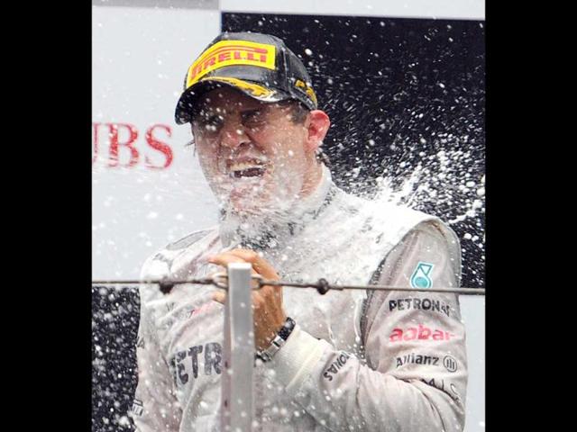 Winner Mercedes-AMG driver Nico Rosberg of Germany is sprayed with champagne on the podium during the awards ceremony after the finish of Formula One's Chinese Grand Prix at the Shanghai International Circuit . (AFP Photo/Liu Jin)