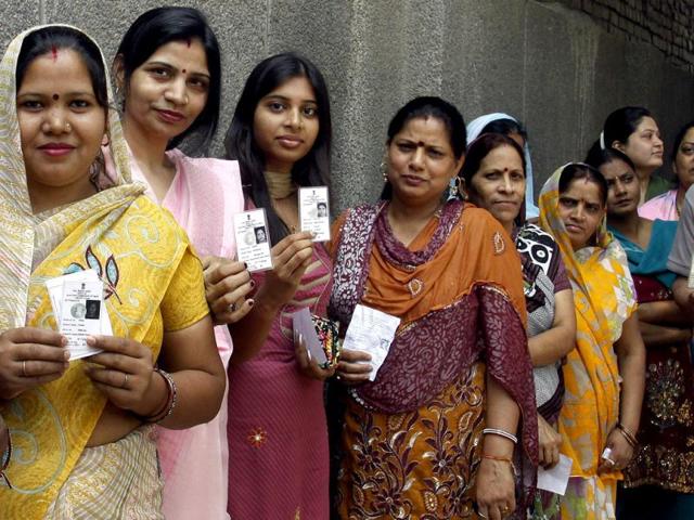 Voters wait in line for their turn to cast votes at a polling booth in Mauj Pur, northeast Delhi. HT Photo by Sonu Mehta