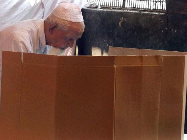 A Muslim voter casts his vote at a polling booth in Matia Mehal during MCD elections in New Delhi. PTI Photo by Atul Yadav