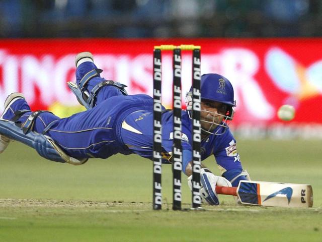 Rajasthan Royals batsman Ajinkya Rahane dives to successfully make it to the crease during their Indian Premier League (IPL) cricket match against Royal Challengers Bangalore in Bangalore. AP/Aijaz Rahi