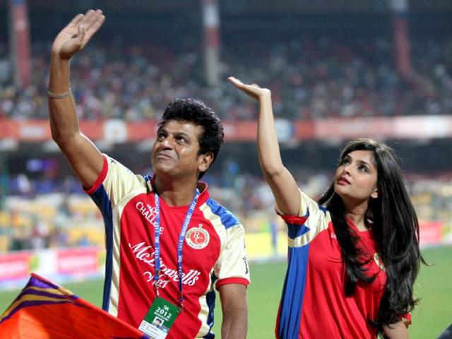 Kannada actors Shivraj Kumar and Ramya wave to the crowd during the IPL 5 match between Rajasthan Royals and Royal Challengers Bangalore at Chinnaswamy stadium in Bengaluru. PTI/Shailendra Bhojak