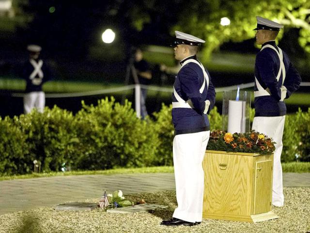 Two Virginia Tech cadets stand at attention next to a candle lit in remembrance on the campus of Virginia Tech in Blacksburg, North Carolina. (Reuters/Chris Keane)