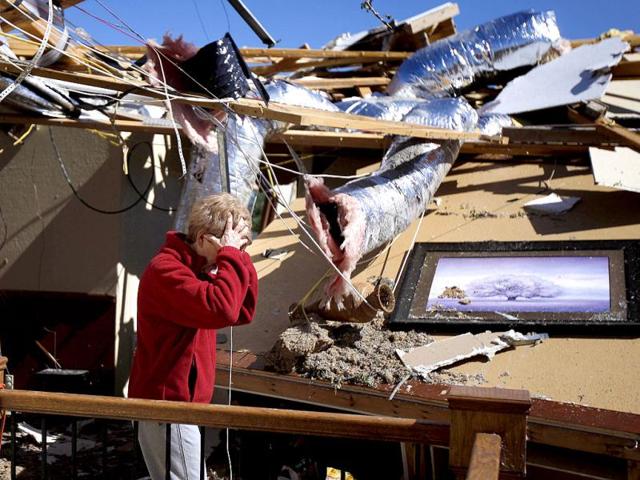 Carole Beckett reacts as she sorts through belongings at her home after a tornado moved through Woodward, Oklahoma. (AP Photo/Bryan Terry)