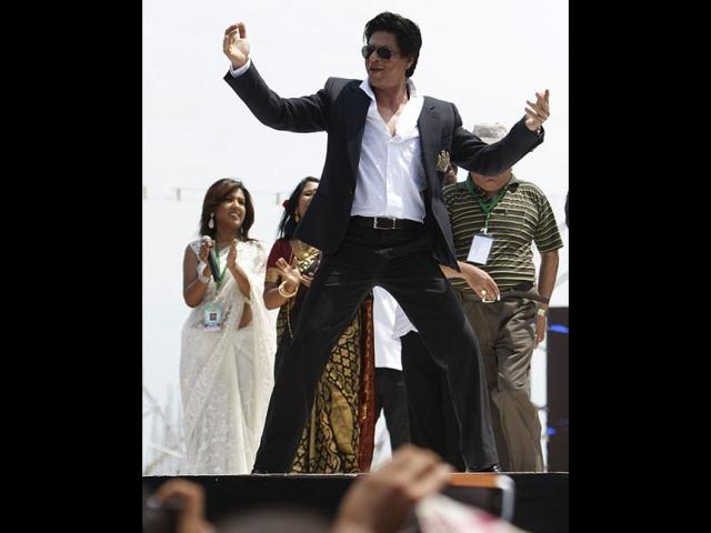 SRK plays to the gallery as he performs at the ceremony.