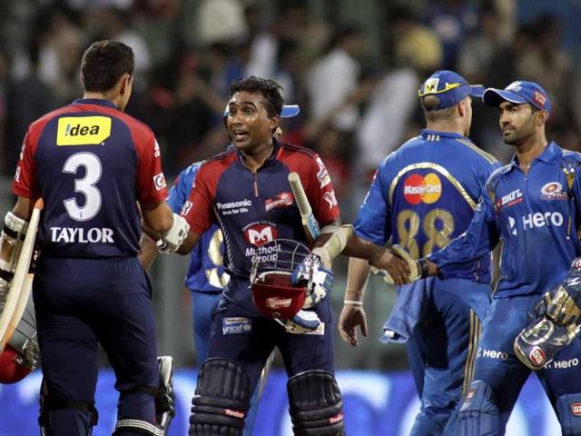 Mahela Jayawardene, second left, of Delhi Daredevils shakes hands with teammate Ross Taylor after their win during the Indian Premier League (IPL) cricket match against Mumbai Indians in Mumbai. Delhi Daredevils won the match by 7 wickets. AP Photo/Rajanish Kakade