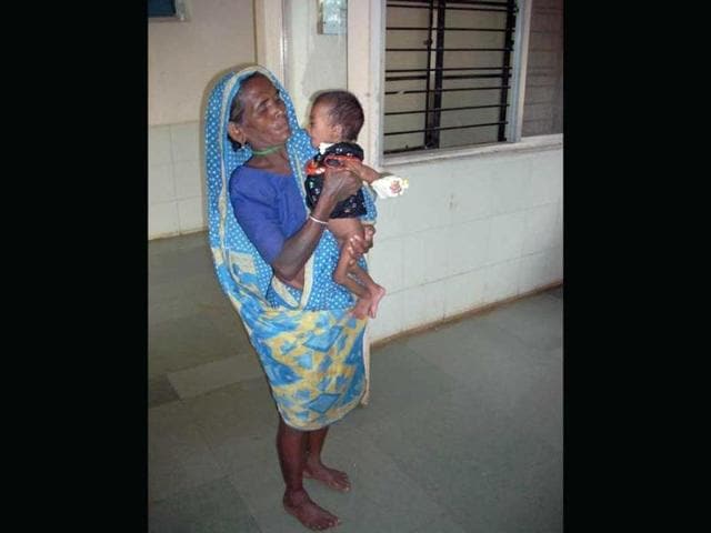 Eleven-month-old Anita Parate with her grandmother. Severely malnourished, Anita received only one meal a day at the child treatment centre at Churni village.