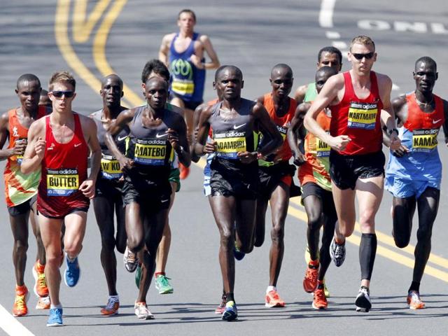 Elite men runners, including Michel Butter, left, of the Netherlands; Levy Matebo, second from left, and Josphat Ndambiri, third from left, of Kenya; Jason Hartmann, second from right, of Boulder, Colo.; and Peter Kamais, right, of Kenya, compete in the Boston Marathon in Wellesley. (AP Photo/Michael Dwyer)