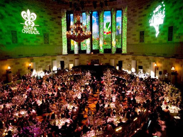 Guests enjoy their meals in the massive dining room of the 2012 Grands Chefs Dinner in New York. (AP Photo/John Minchillo)