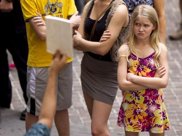 A young girl makes a face as she watches members of the Occupy movement protest on the steps of Federal Hall near the New York Stock Exchange in New York. (Reuters/Lucas Jackson)