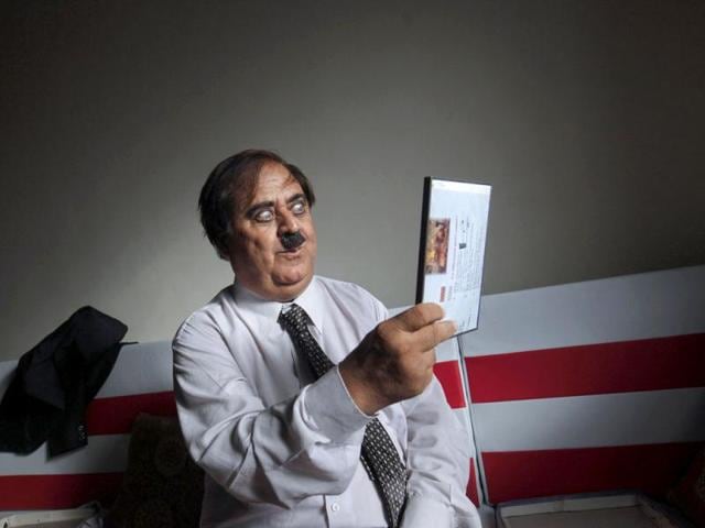 Ashok Aswani gestures as gets dresses up as Charlie Chaplin in his house in Adipur in Gujarat. (Reuters/Danish Siddiqui)
