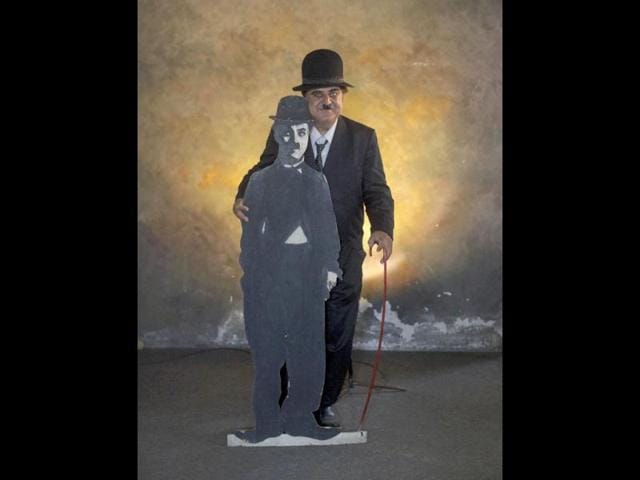 Ashok Aswani poses with a cut-out picture of Charlie Chaplin inside a studio in Adipur in Gujarat. (Reuters/Danish Siddiqui)